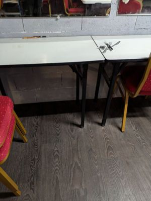 two red chairs sitting in front of a table with a mirror