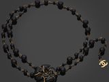 a black beaded necklace with a gold heart charm