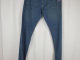 a close up of a pair of jeans hanging on a hanger
