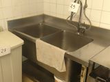a kitchen with a sink, stove, and a dishwasher