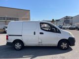 a white van parked in a parking lot near a building