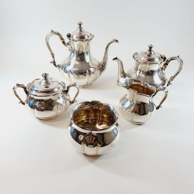 four pieces of silver tea and coffee set on a white background