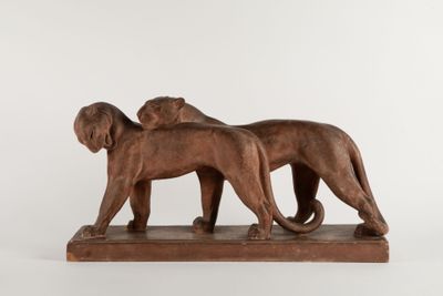 pair of bronze lions on a marble base