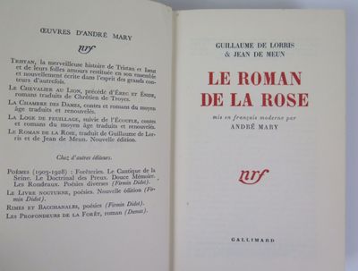 an open book sitting on top of a table next to a white table