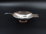 an image of a silver spoon on a black surface