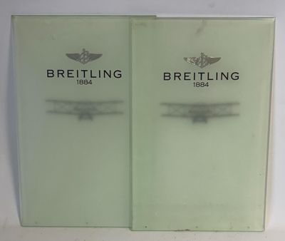 these are two booklets with the words breitling on them