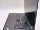 a laptop computer sitting on a white surface with a black keyboard