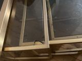 a glass table with a metal frame on top of it