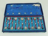 a blue box with silver spoons and spoons in it