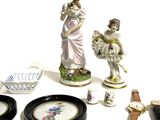 several figurines are displayed on a white surface with black plates