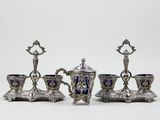 four pieces of silver and blue glass on a white surface