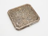 an antique silver cigarette case on a white background