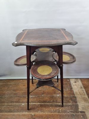 a small table with three trays on top of it