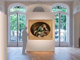 a large painting hanging on the wall in a large room