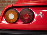 a close up of the tail lights of a red sports car