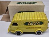 a yellow toy truck that is sitting next to a box