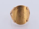 a close up of a gold coin ring with a woman ' s face on it