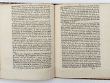 an open book on a white table with a black border