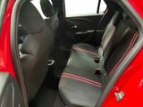 the interior of a red car with black seats and red trims