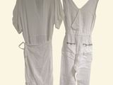 pair of white jumpsuits hanging on a hanger on a white background