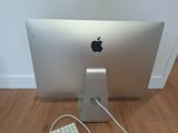 an apple computer with a keyboard and mouse on the floor