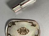 a small silver object and a small silver object on a table
