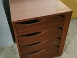 a small wooden cabinet with three drawers in it
