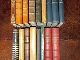 a lot of books that are stacked on top of each other