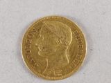 a close up of a gold coin on a white surface