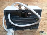 a black and white heater with a white hose connected to it