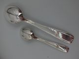 two spoons and a spoon on a table
