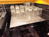 many empty glasses on a metal tray in the kitchen