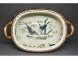 two birds sitting on a plate on a table