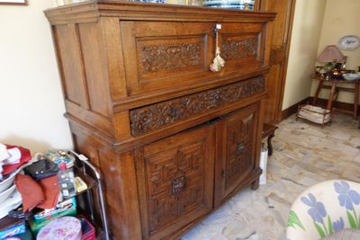 a dresser with a mirror on top of it in a living room