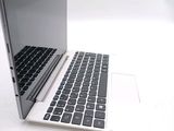 a white laptop with a black keyboard sitting on a table