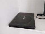 a laptop computer sitting on top of a white shelf