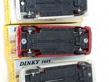 three black and red toy trains sitting on top of each other