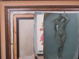 a painting of a nude woman on display in a picture frame