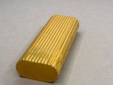 a gold lighter that is sitting on a table