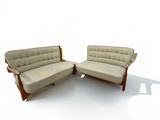 two chairs that are sitting side by side on a white surface