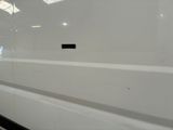 a white van parked in a building with a sign on the side of it