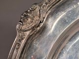 a silver plate with a lion head on it
