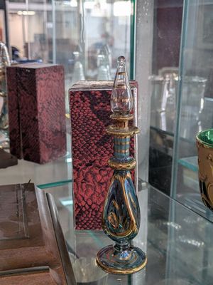 a glass display case with various glass items on it