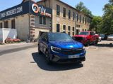a blue car parked in front of a building in a parking lot