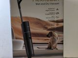 the box of a vacuum cleaner with a dog sitting on the floor