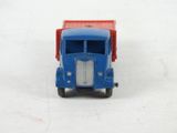 a toy truck that is sitting on a white surface
