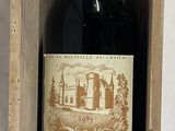 a bottle of wine in a wooden box on a table