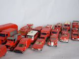 a lot of red toy trucks that are lined up together