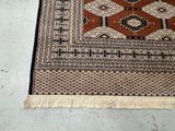 a rug on the floor with a cat laying on it