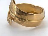 an image of a gold ring sitting on top of a white surface